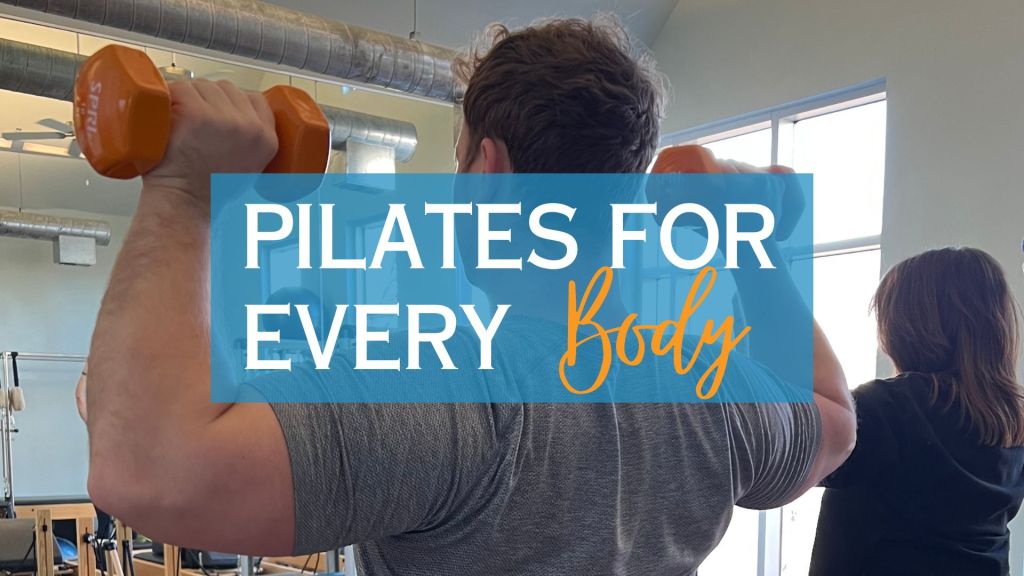 Man holding dumb bells in Pilates class